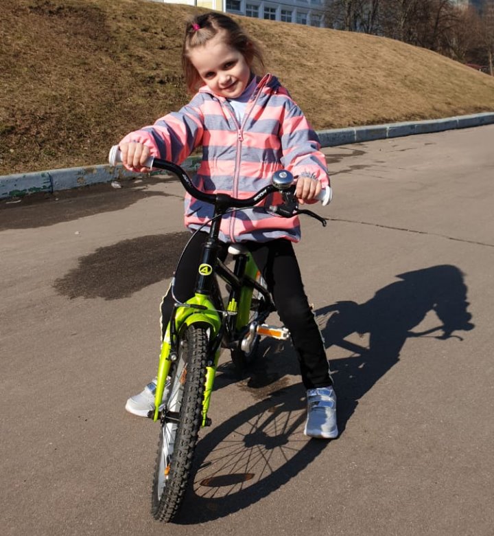 Alice is learning to ride her bike.